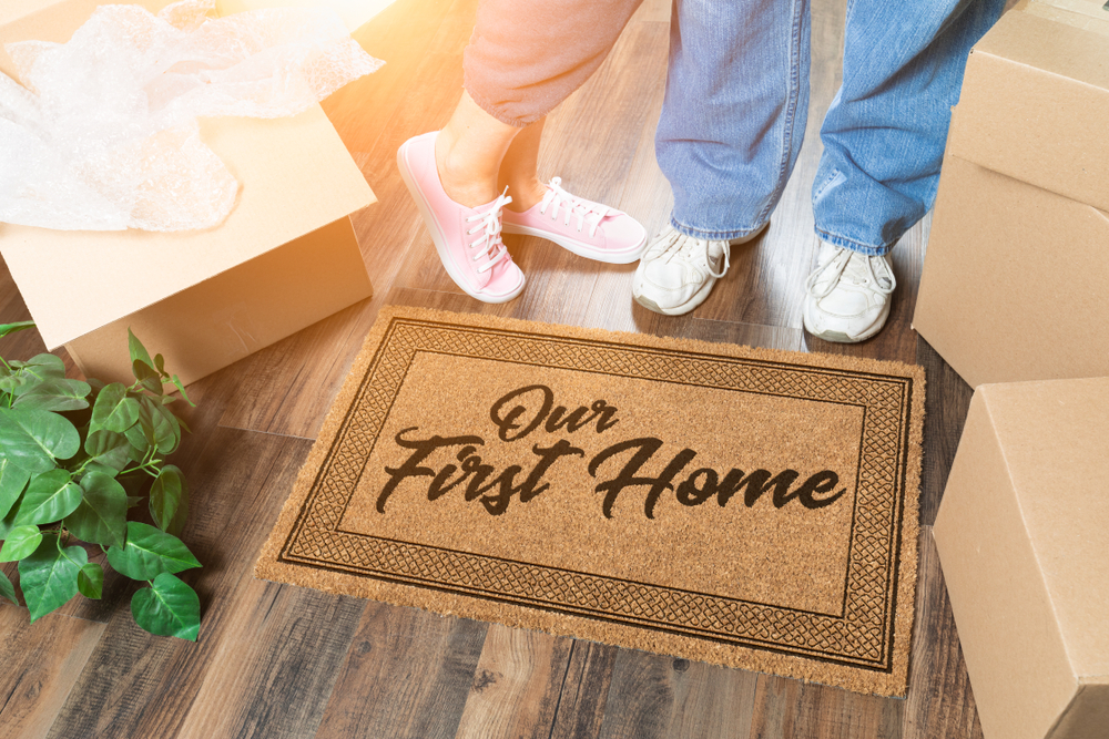 Our first home written on a welcome mat